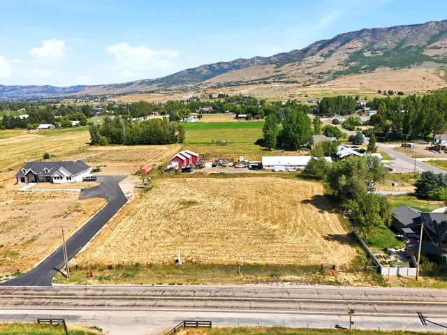 Expansive land parcel featuring open fields and distant mountain scenery