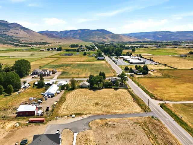 Expansive land parcel featuring open fields and distant mountain scenery