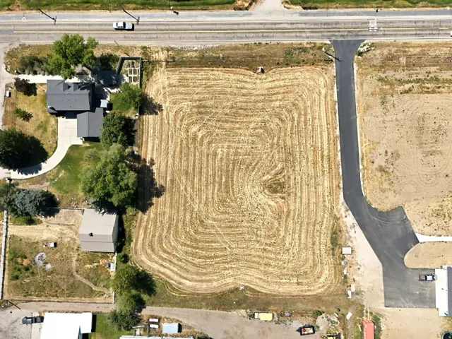 Expansive cleared lot featuring defined boundaries and adjacent to a paved access road