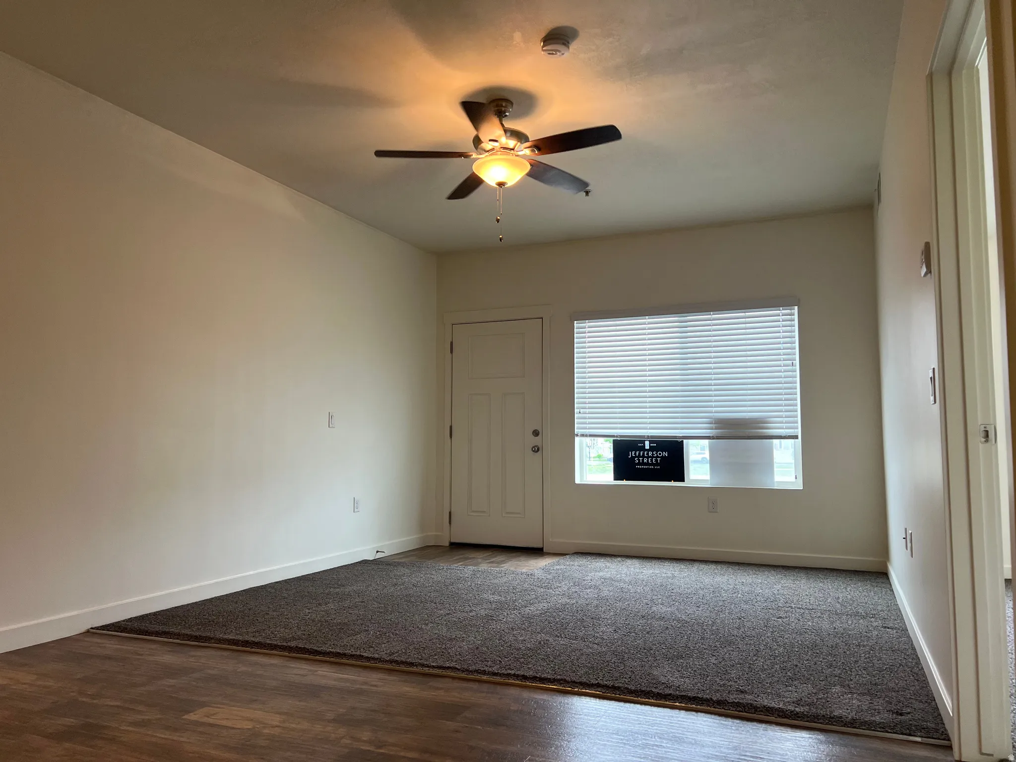 Spare room featuring wood finished floors and a ceiling fan