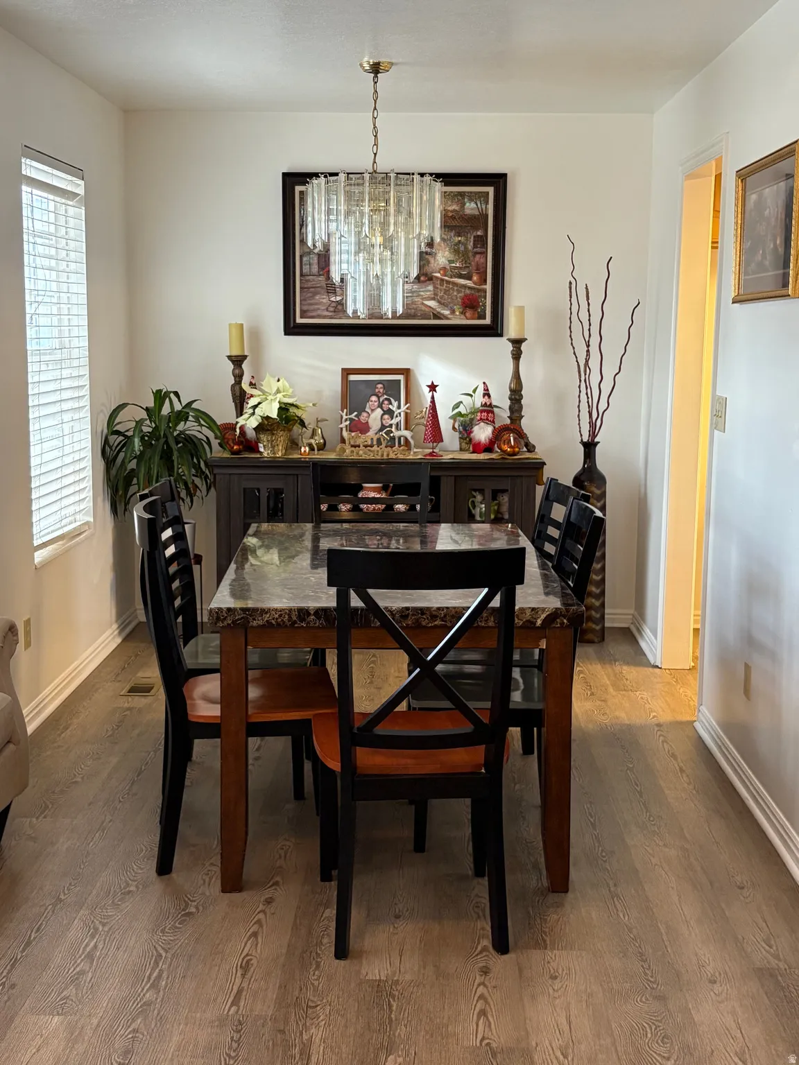 Dining area featuring light wood-style floors and a chandelier