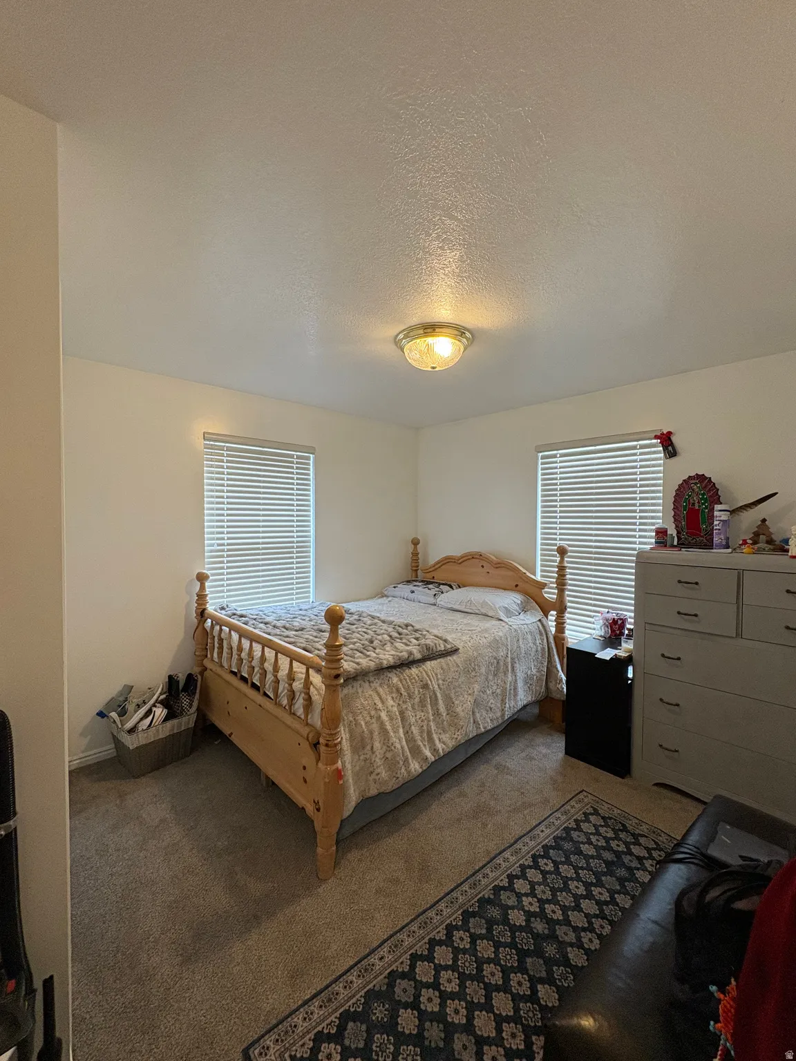 Bedroom with carpet floors and a textured ceiling