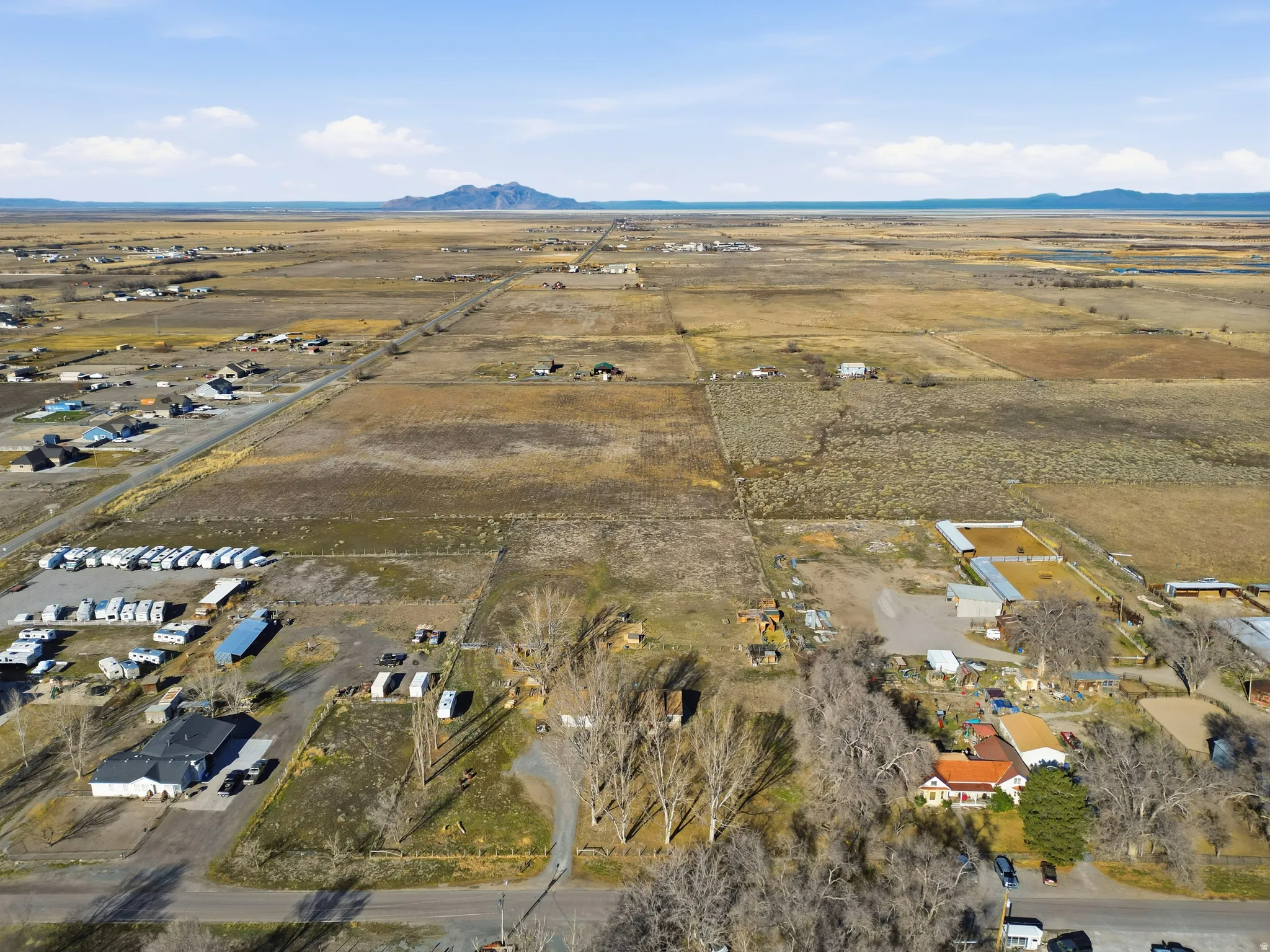 Aerial view of property and surrounding area with rural landscape and a mountain backdrop