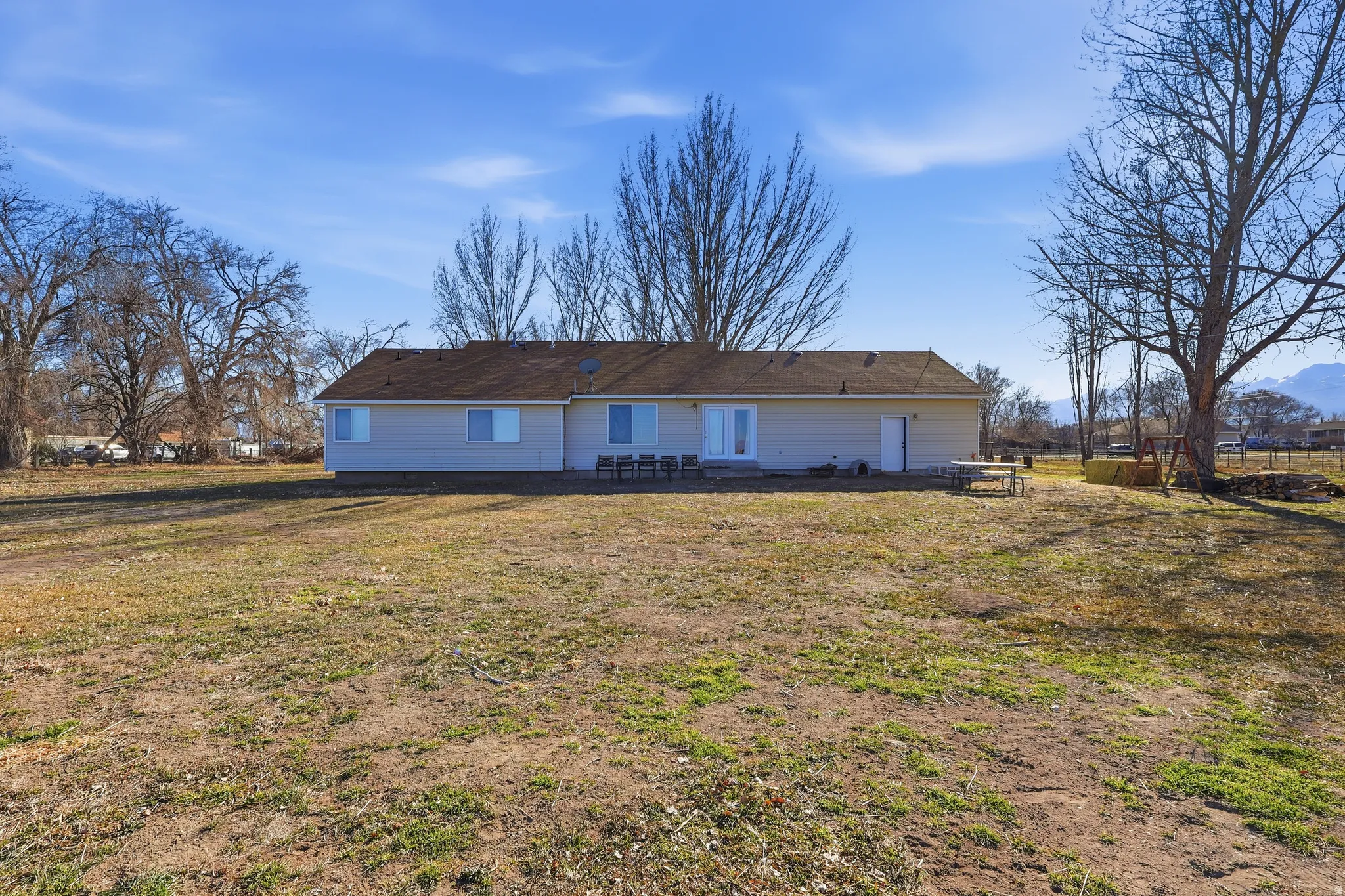 Back of property featuring a patio area and a yard