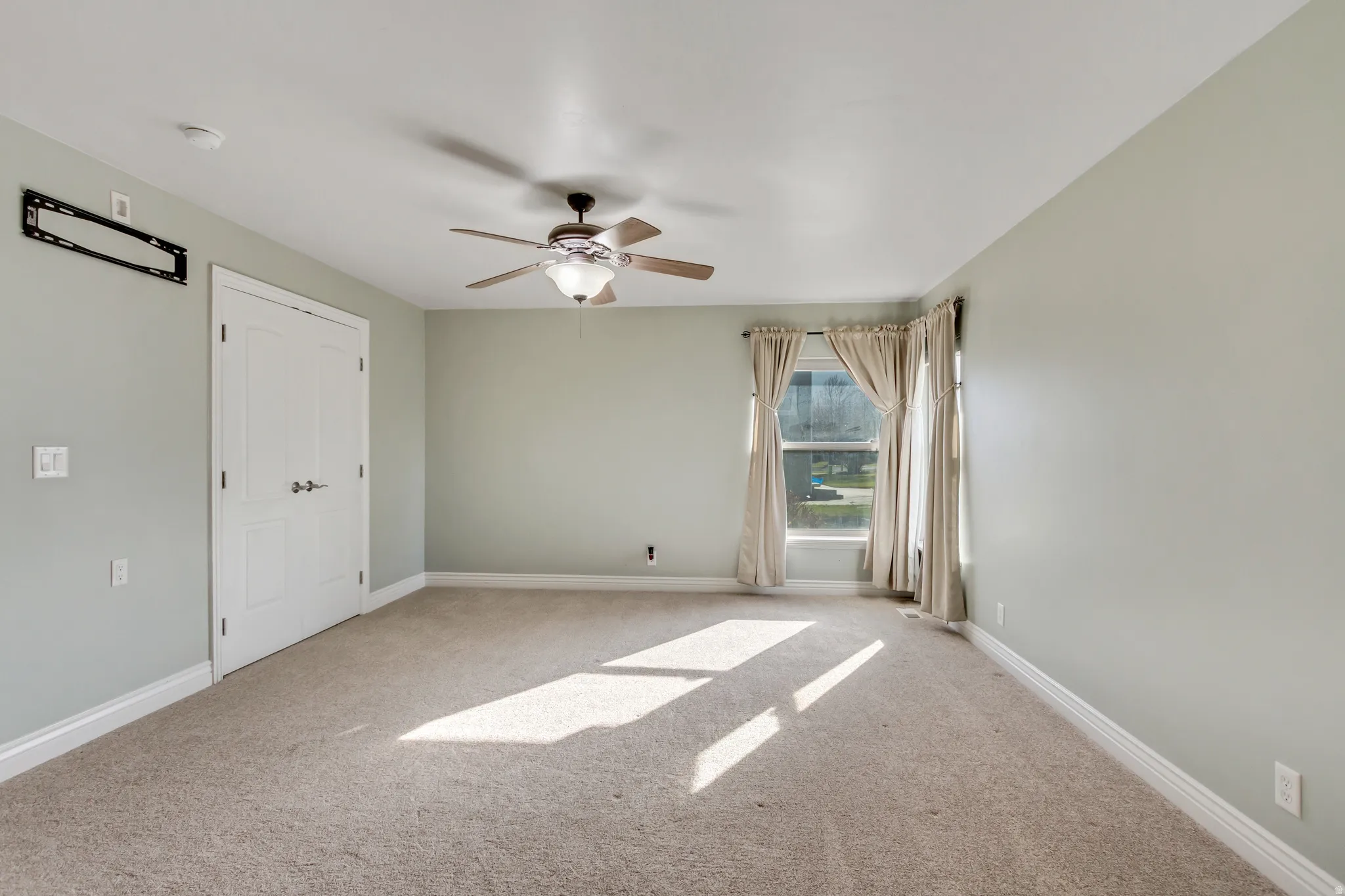 Unfurnished bedroom featuring carpet floors and a ceiling fan