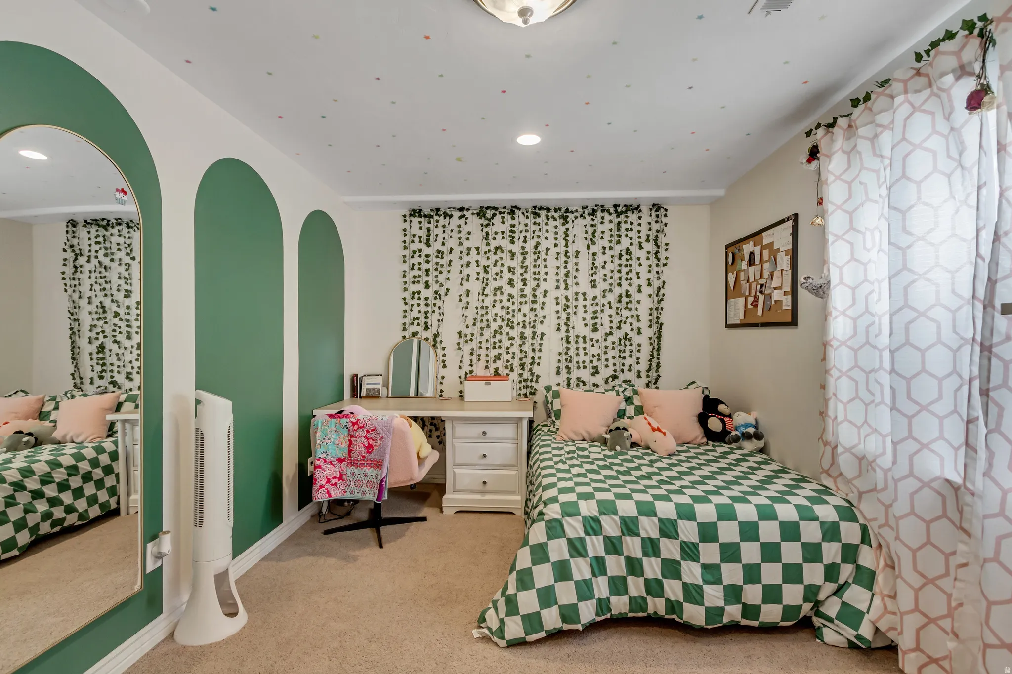 Bedroom with light carpet, arched walkways, and recessed lighting