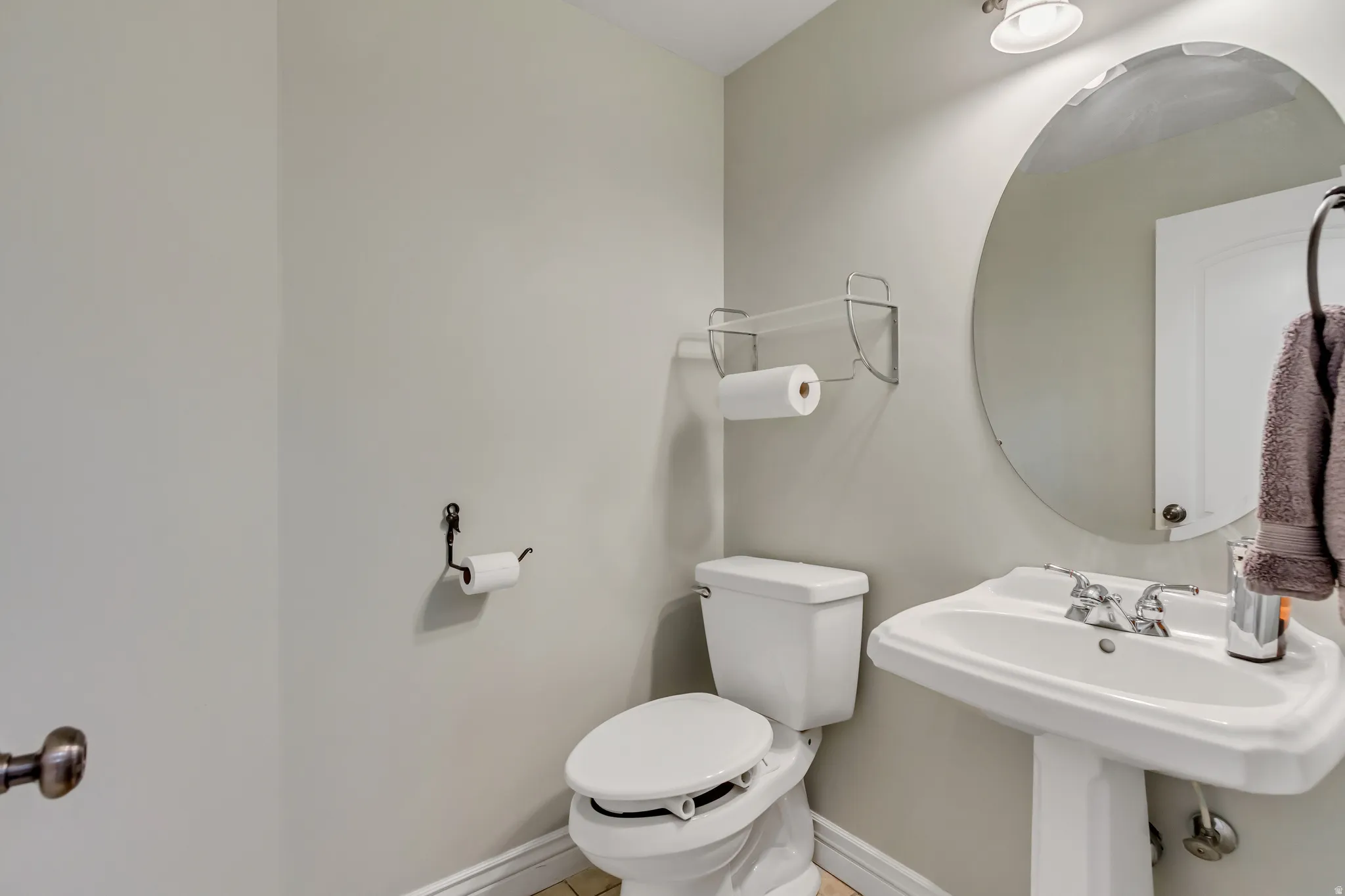 Bathroom with baseboards and tile patterned flooring