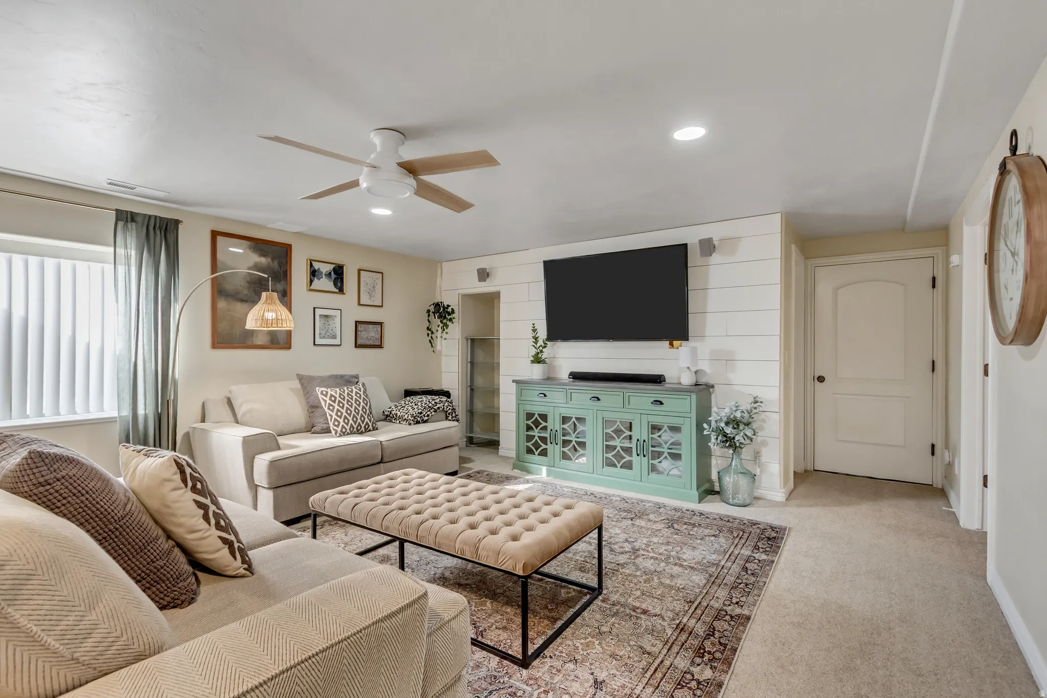 Living room with light colored carpet, a ceiling fan, and recessed lighting