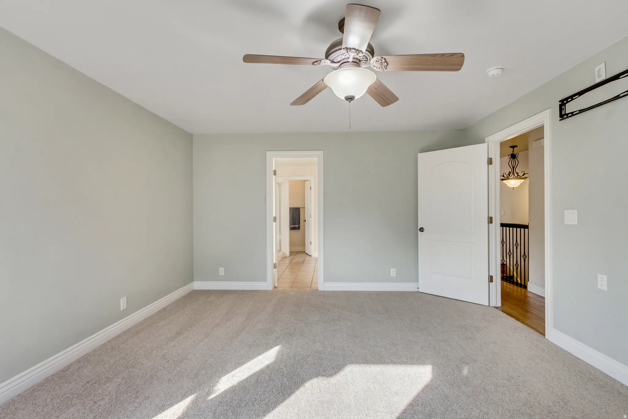 Unfurnished bedroom featuring carpet flooring and a ceiling fan