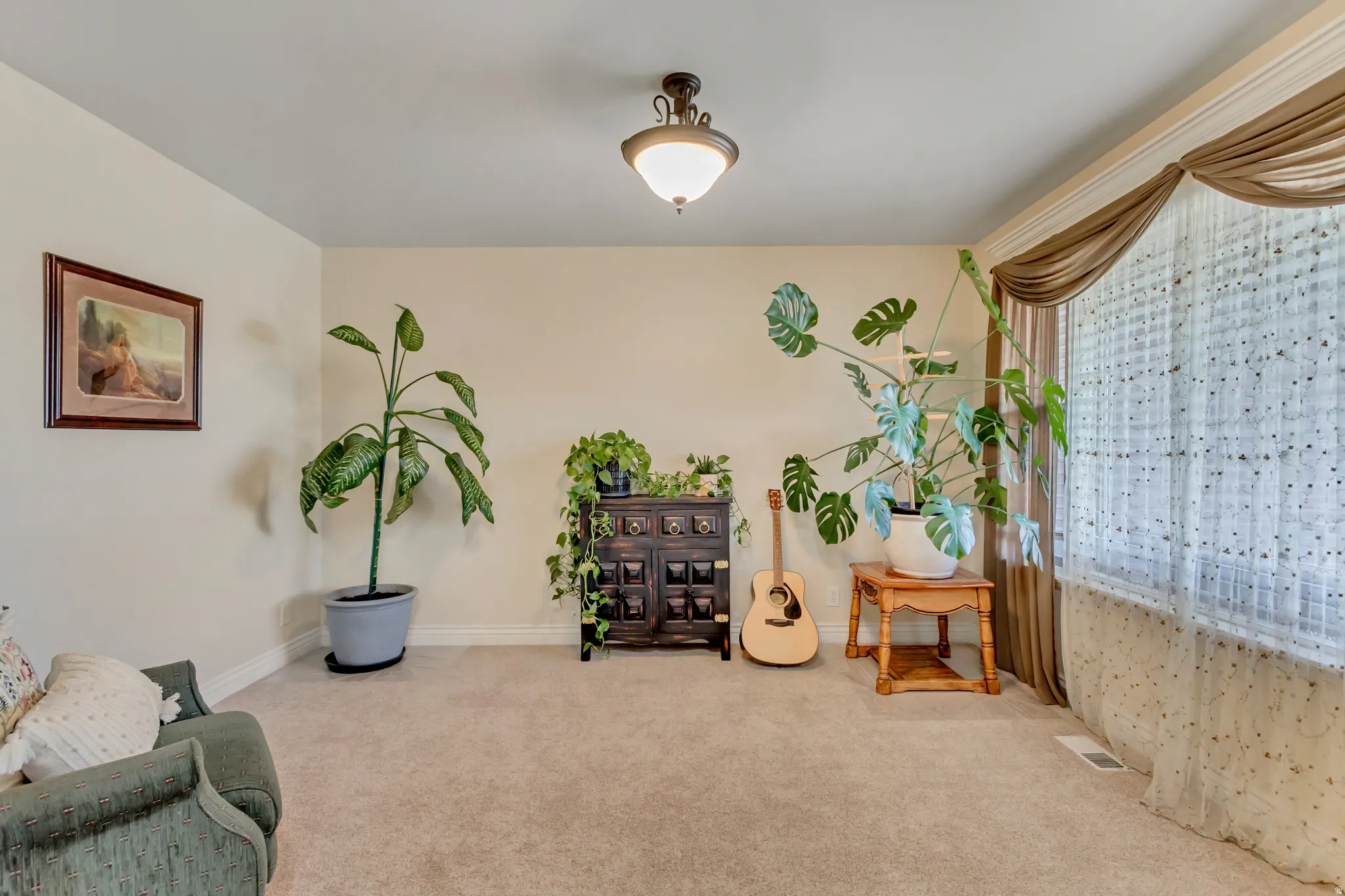 Sitting room with carpet flooring and baseboards