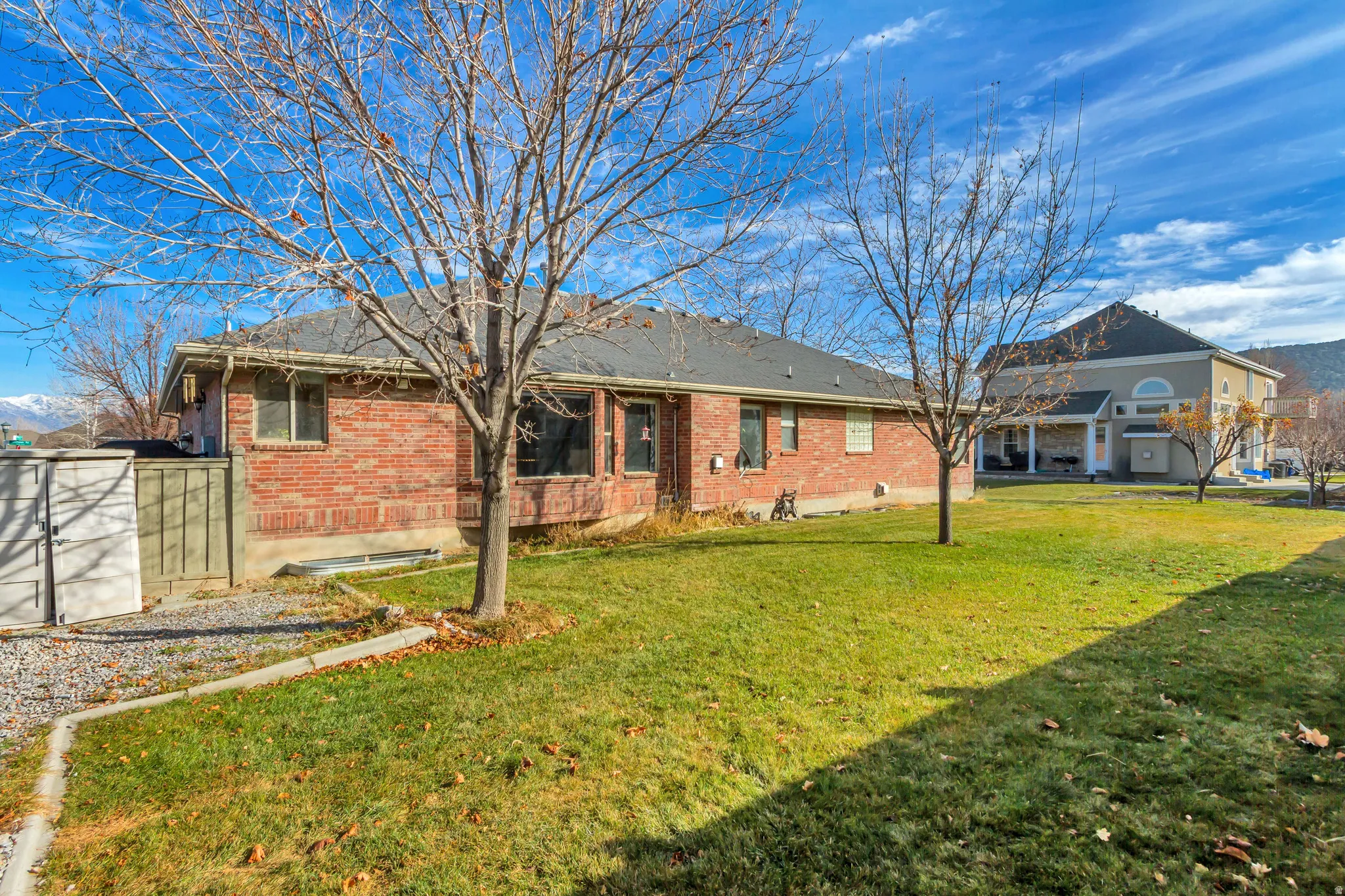 Rear view of property featuring brick siding and a yard