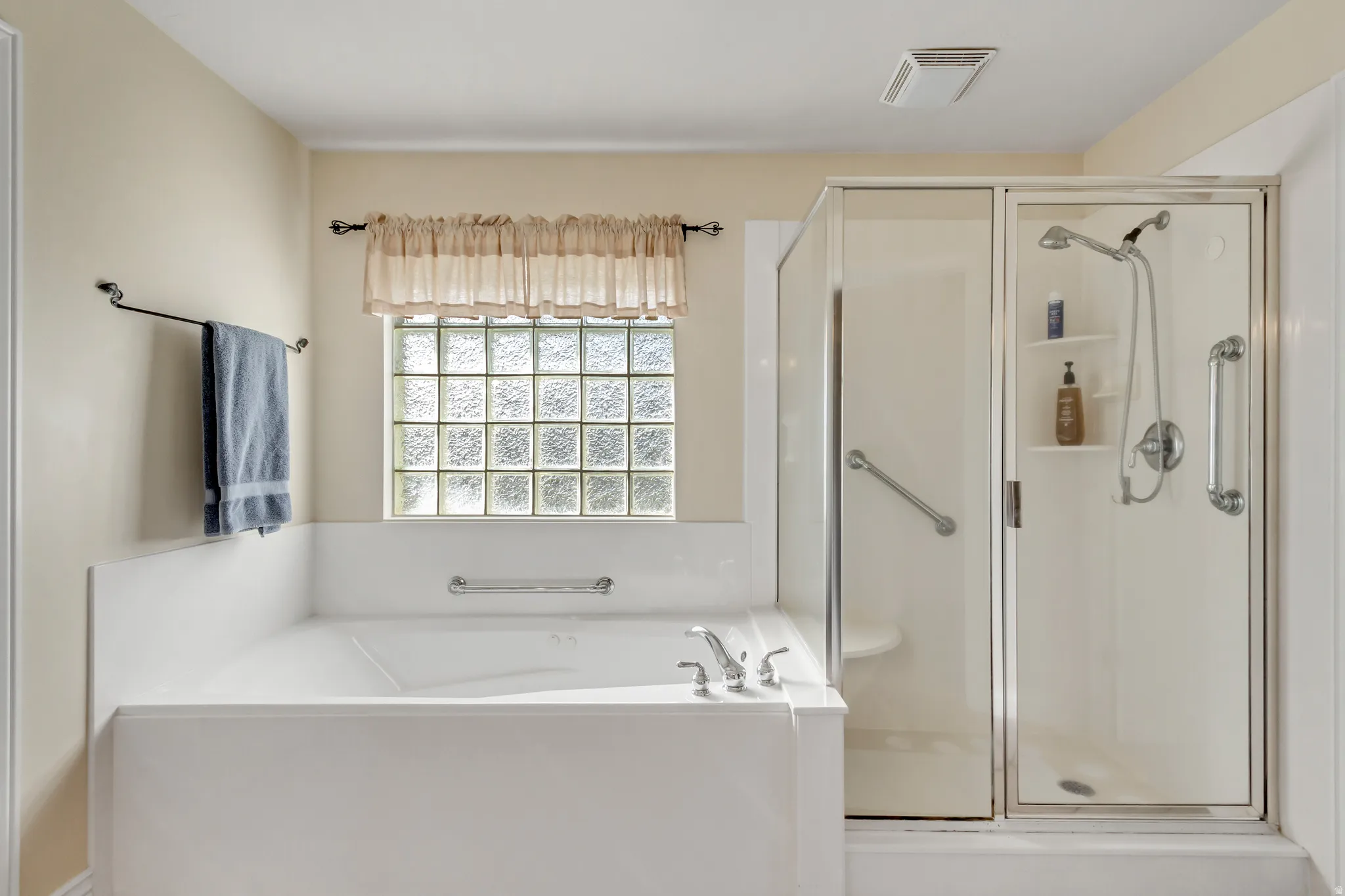 Full bathroom featuring a shower stall and a bath