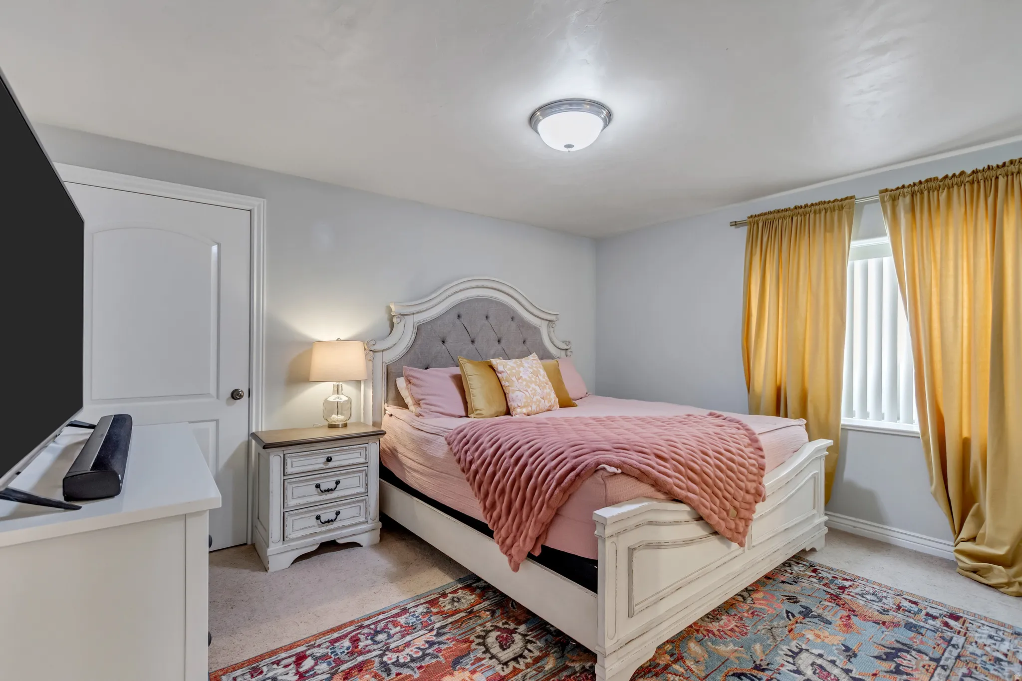 Bedroom with light carpet