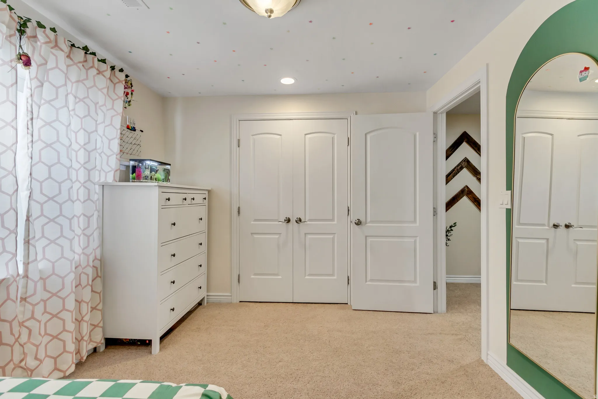 Bedroom featuring light colored carpet and baseboards