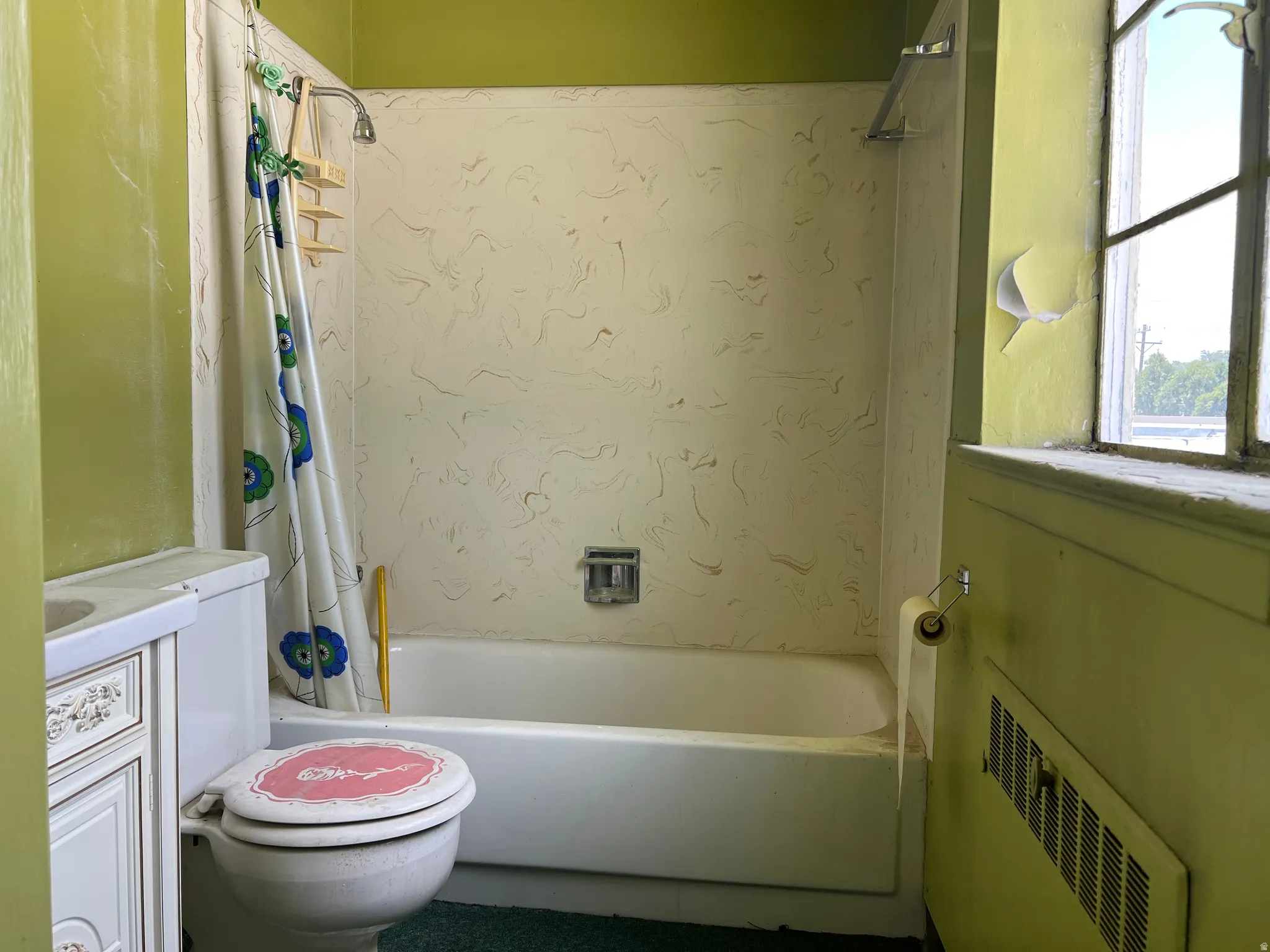 Full bathroom featuring shower / bath combo with shower curtain, radiator, and vanity