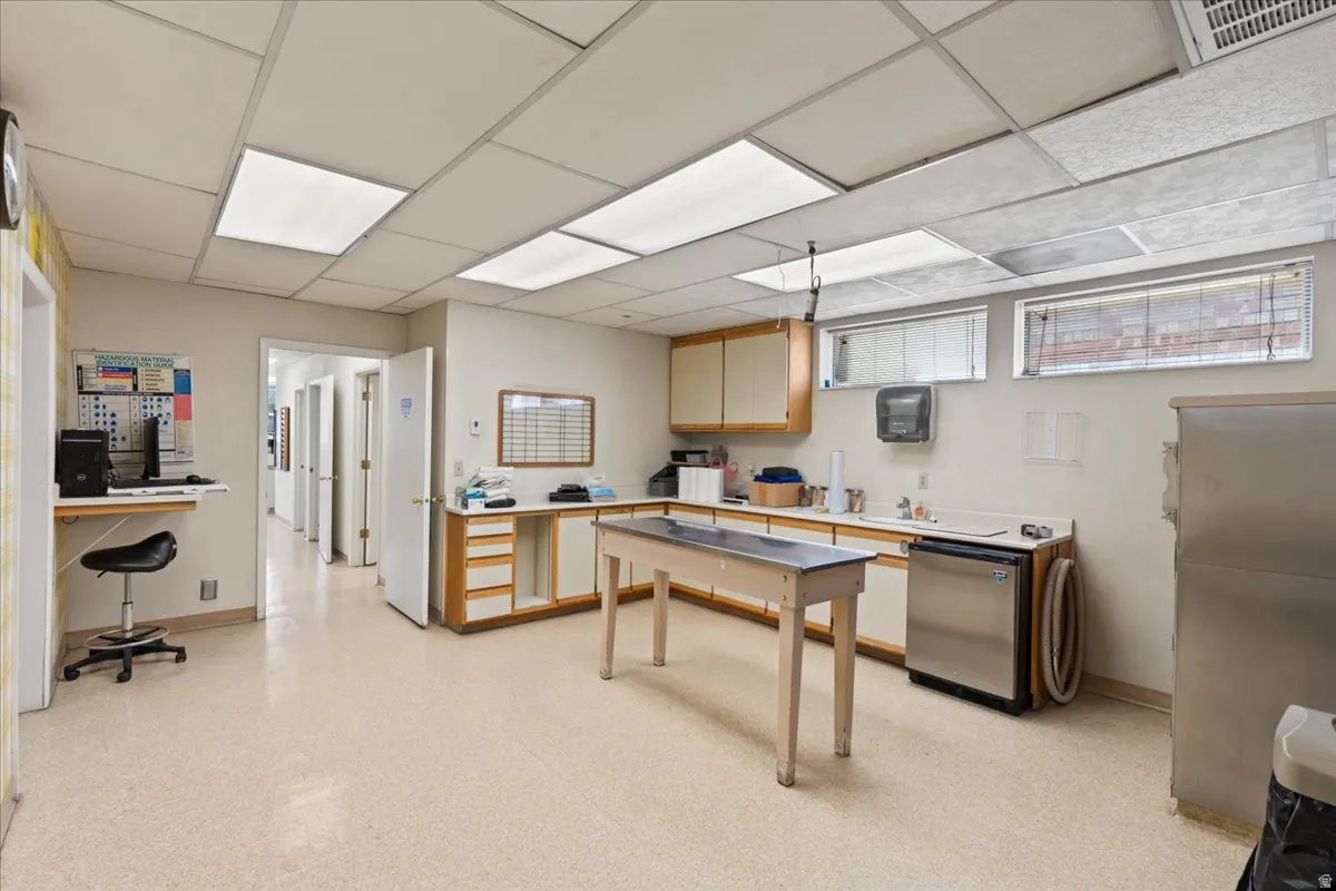 Office featuring a drop ceiling and baseboards