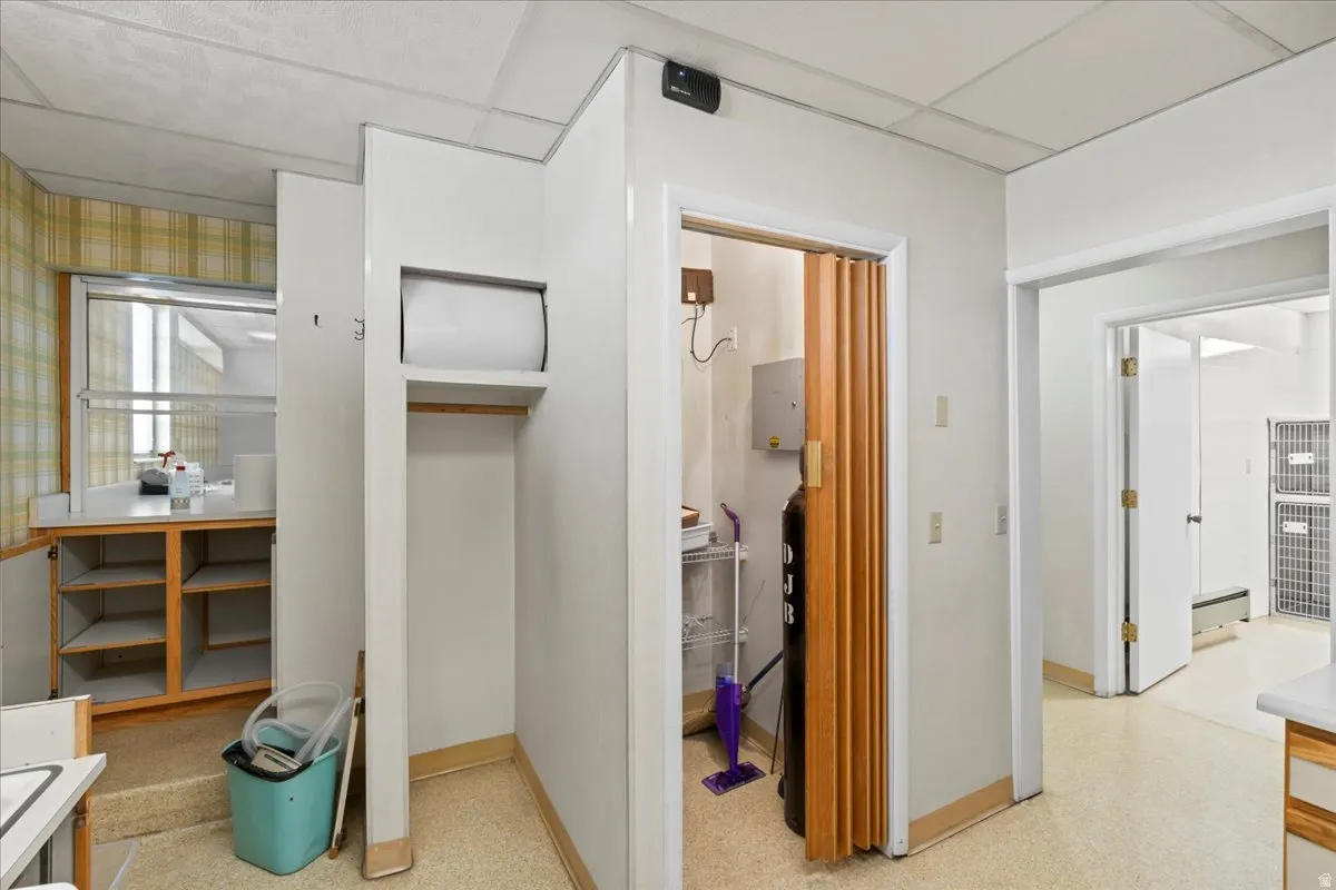 Hallway with a heating unit and baseboards