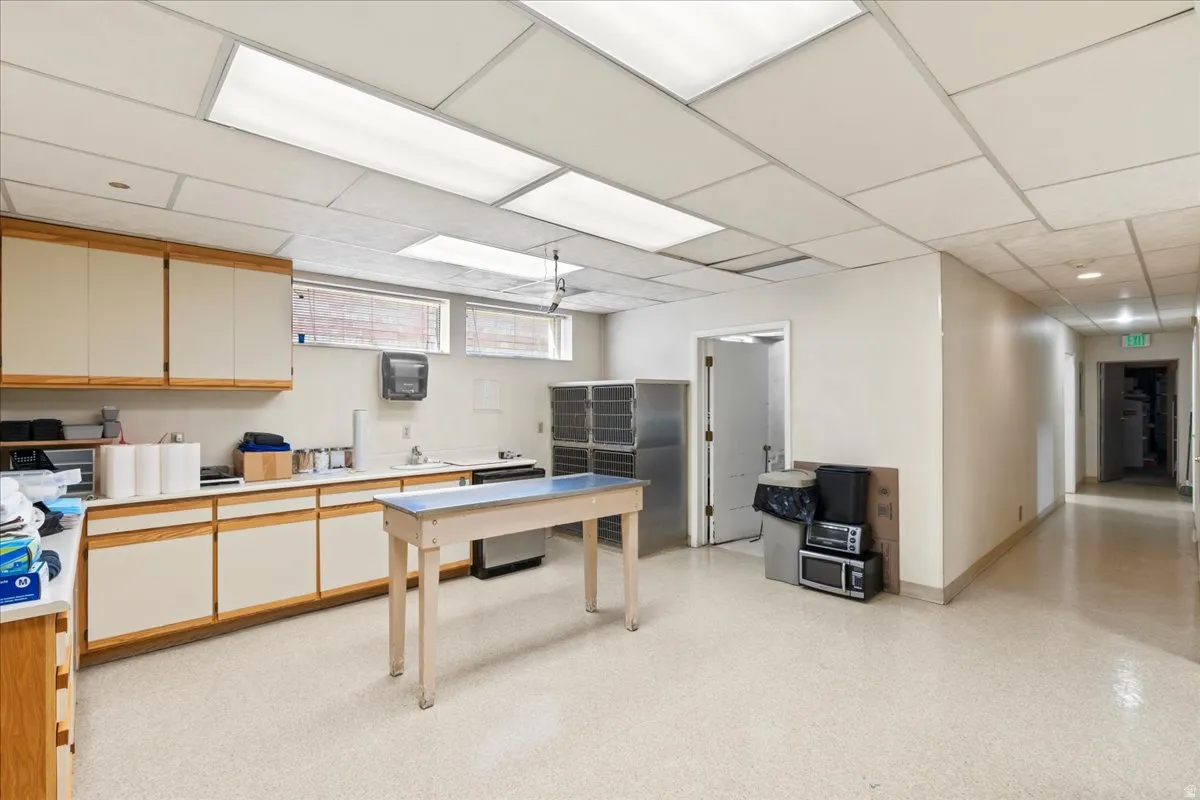 Office featuring a drop ceiling and a sink
