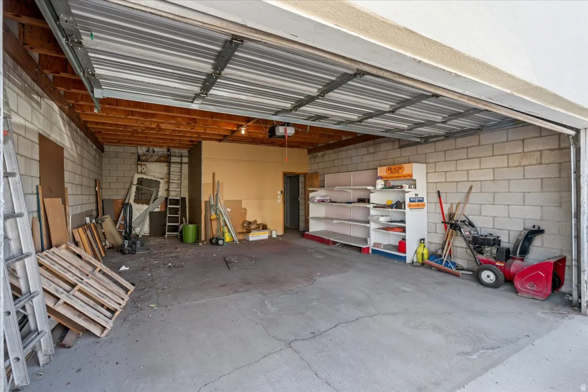 Garage featuring concrete block wall