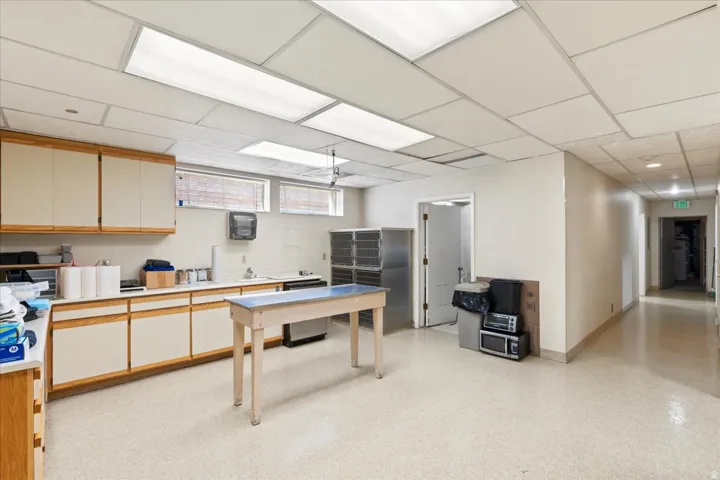 Office featuring a drop ceiling and a sink