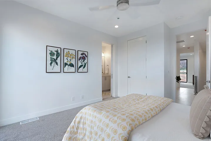 Carpeted bedroom featuring recessed lighting, ensuite bathroom, a ceiling fan, and a closet