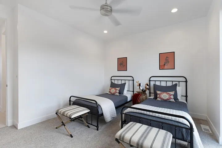 Carpeted bedroom with ceiling fan and recessed lighting