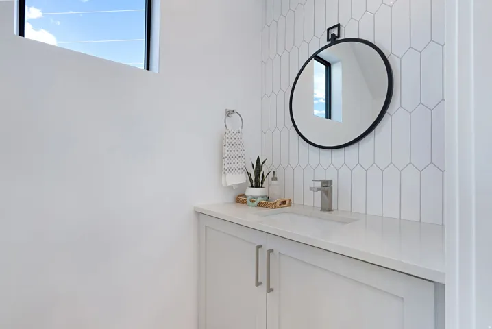 Bathroom with vanity and decorative backsplash