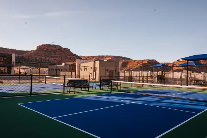 View of tennis court with a mountain view and community basketball court