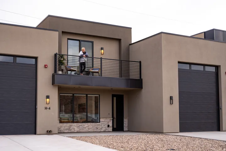 View of front facade featuring stucco siding and a balcony