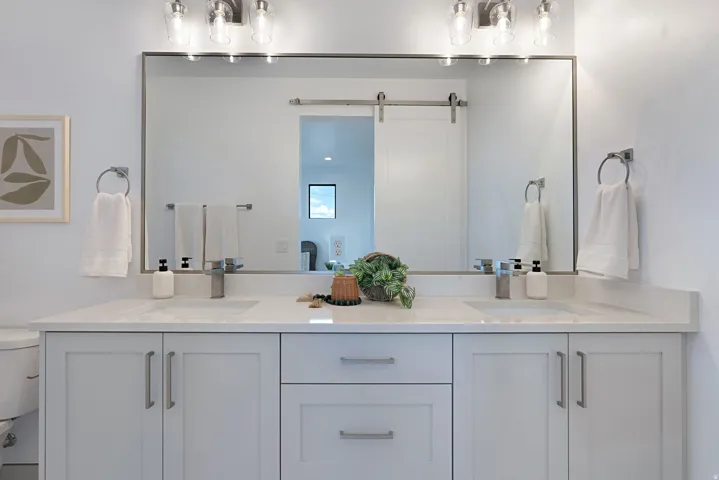 Bathroom with double vanity and toilet
