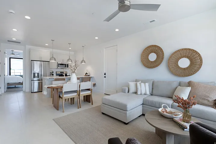 Living area with a ceiling fan and recessed lighting