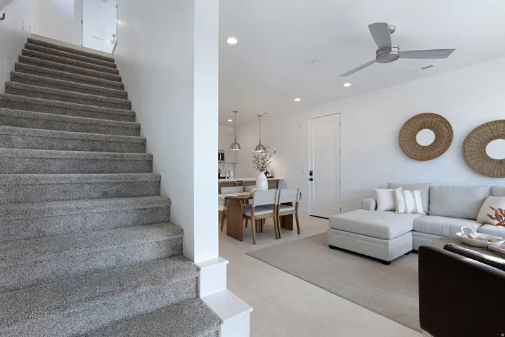 Living area featuring recessed lighting, stairs, and ceiling fan