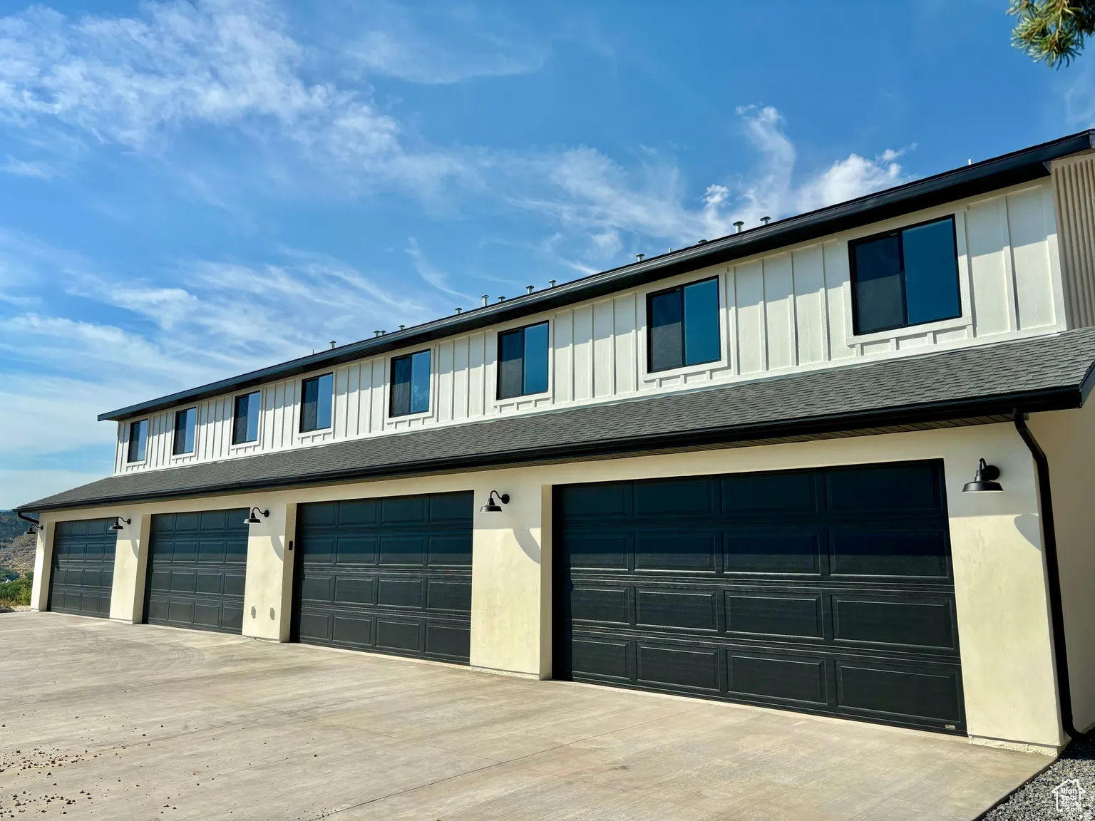 Garage featuring concrete driveway