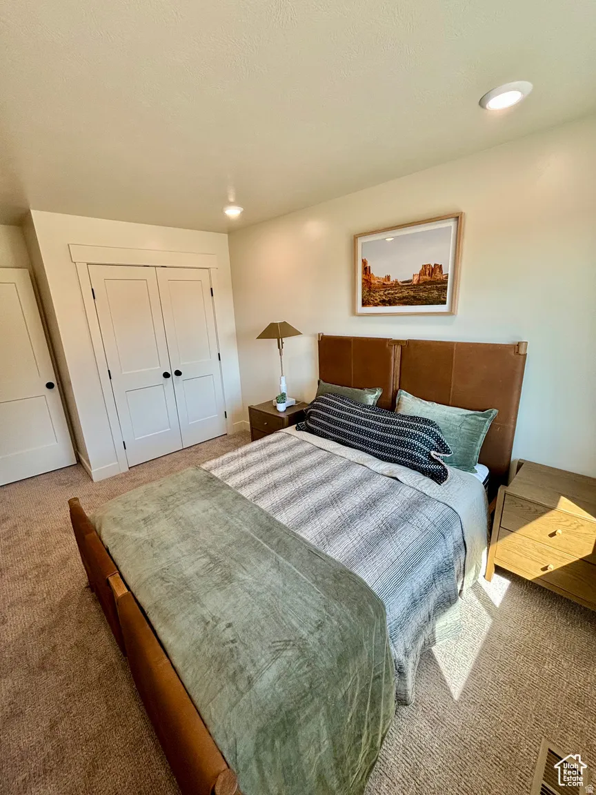 Carpeted bedroom featuring a closet and recessed lighting