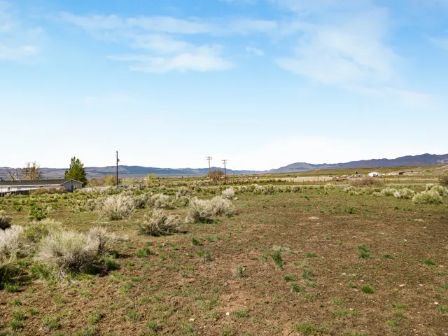 View of mountain backdrop with rural landscape