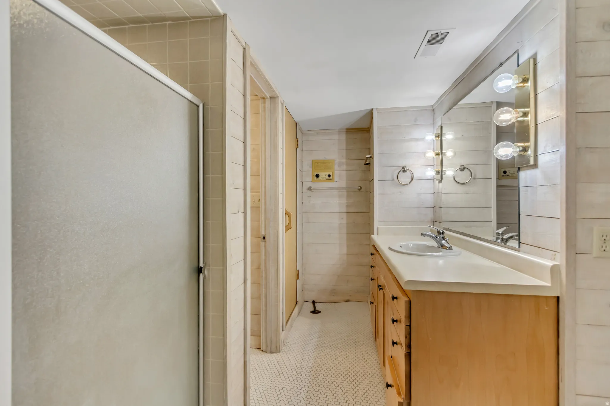 Bathroom with vanity and a shower stall
