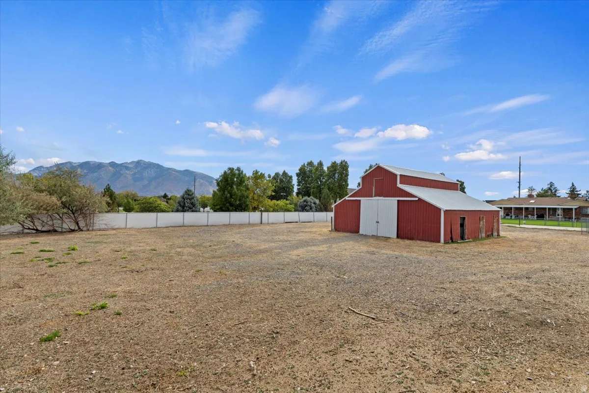 View of yard featuring a mountain view and an outbuilding