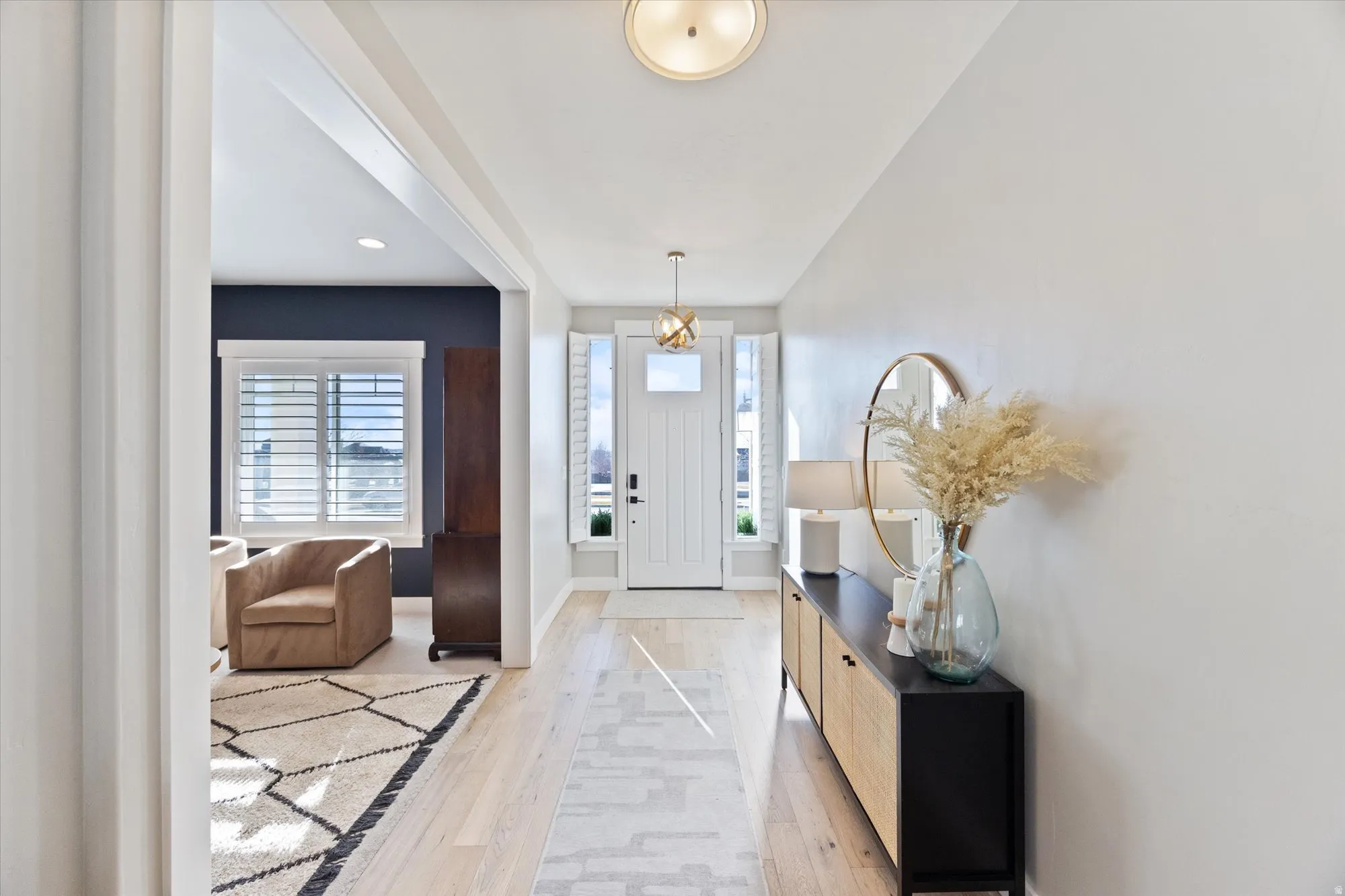 Light and bright entryway featuring beautiful hardwood floors and living room