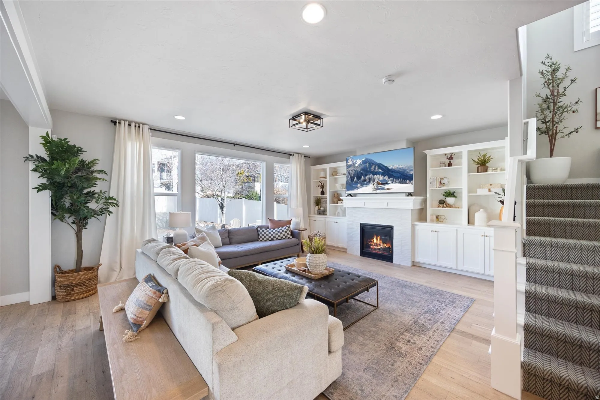 Beautiful family room featuring built in shelving and fireplace