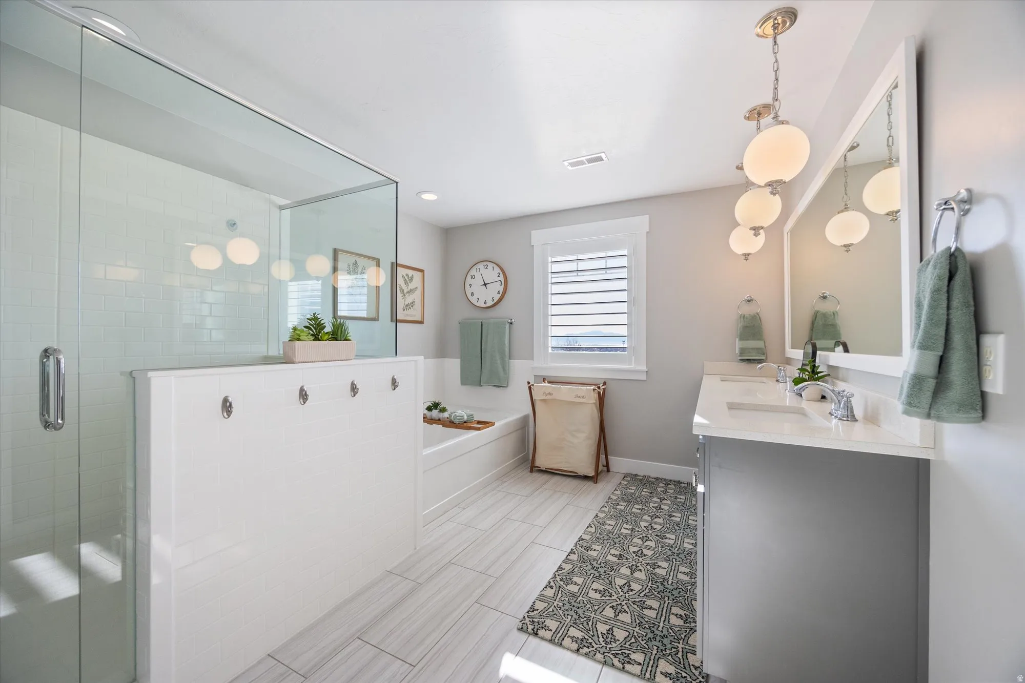Primary bathroom with a garden tub, double vanity, and a separate shower