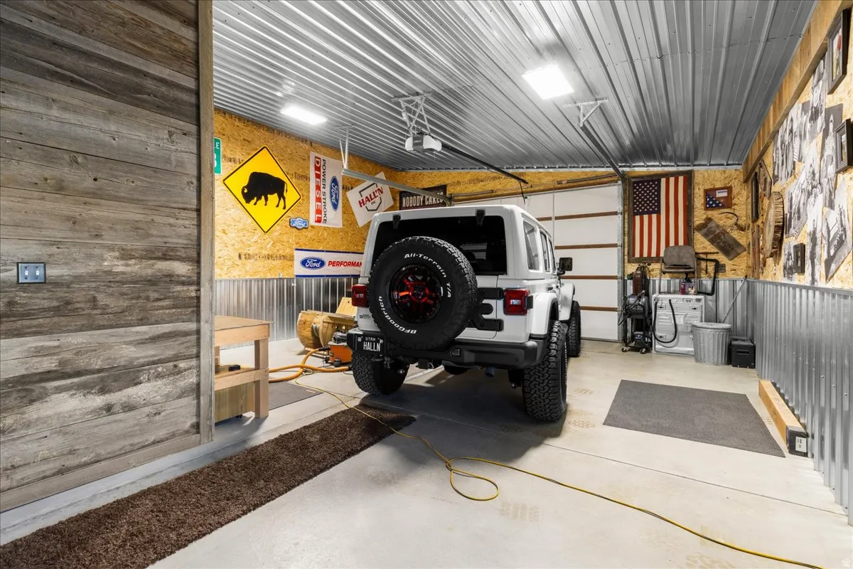 Garage featuring wooden walls and metal wall