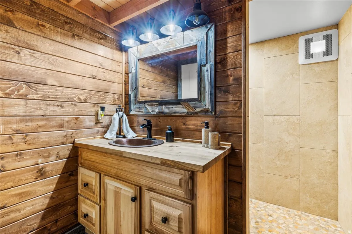 Bathroom with wood walls and vanity