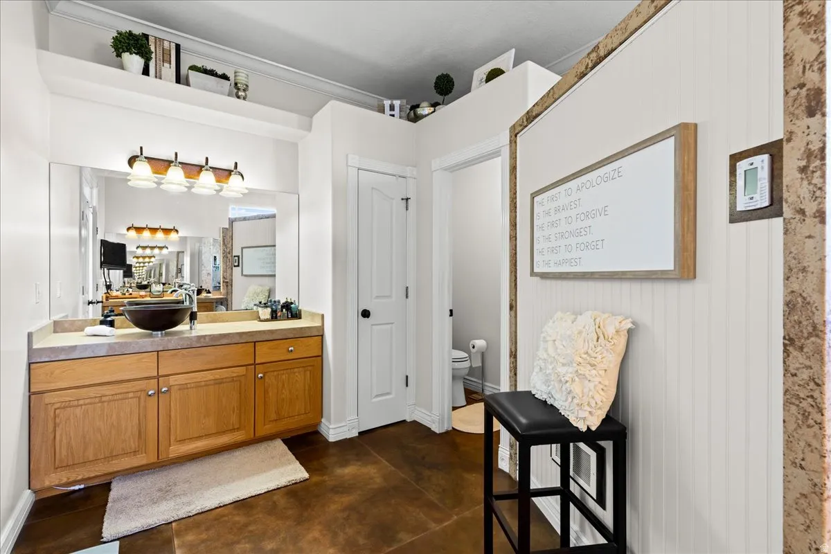 Full bathroom with finished concrete floors and vanity