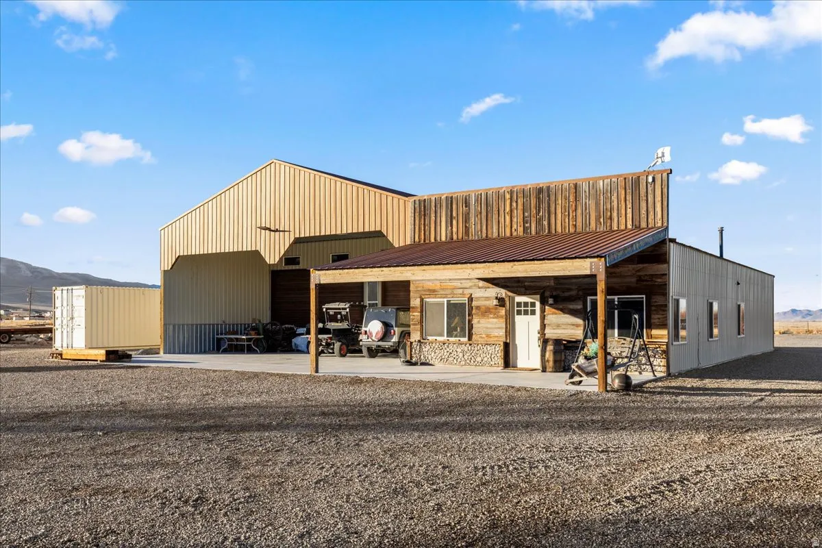 View of building exterior with a mountain view and an outbuilding