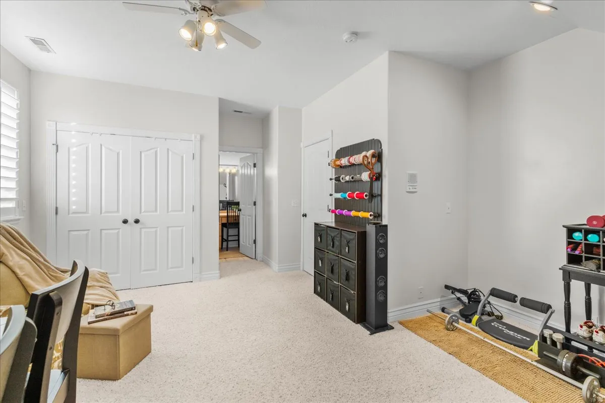 Game room featuring light colored carpet and ceiling fan