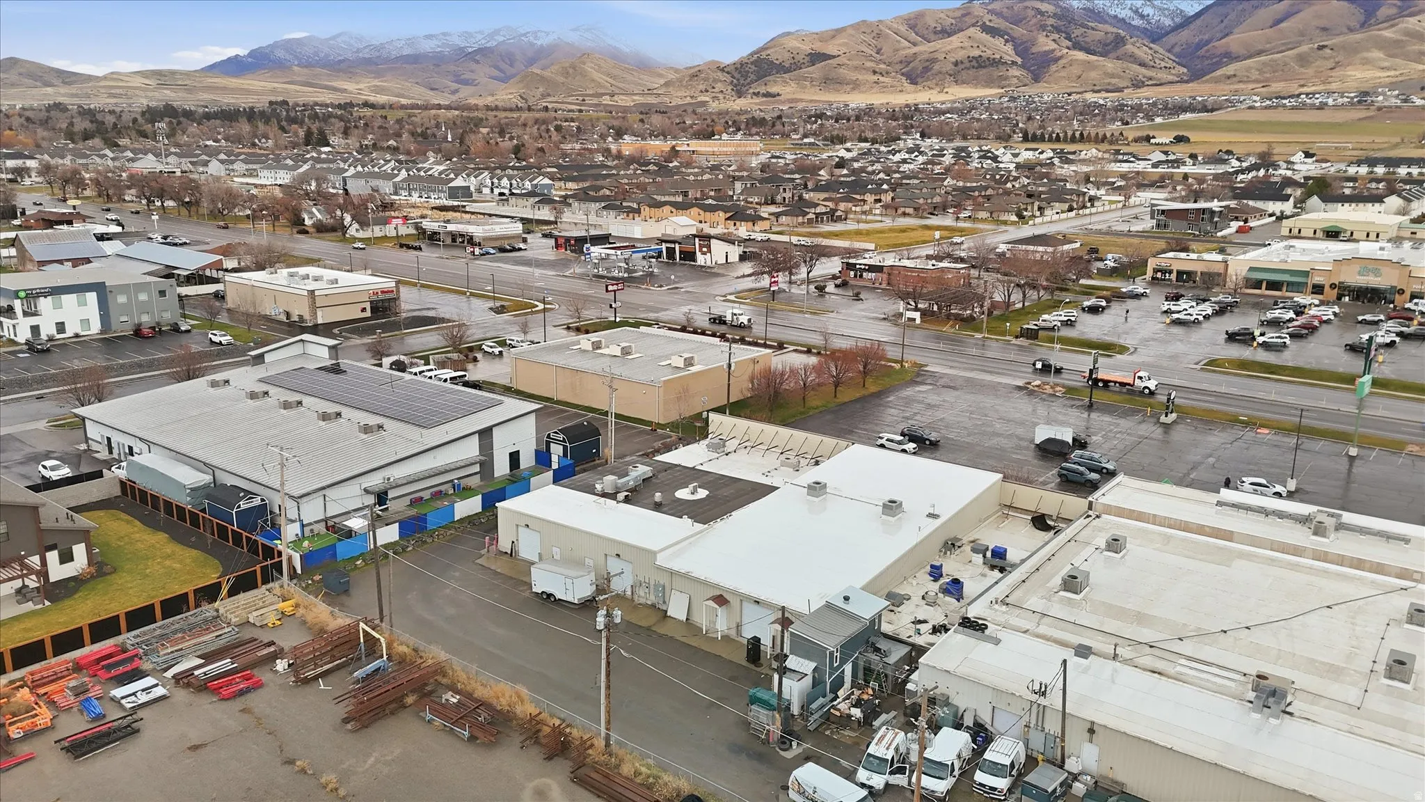 Drone / aerial view of an industrial area and a mountainous background