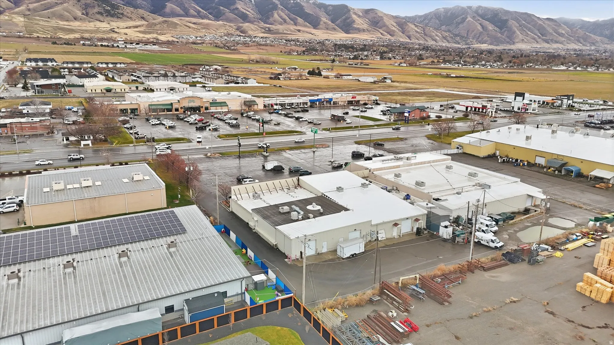 Drone / aerial view of industrial structures and a mountainous background