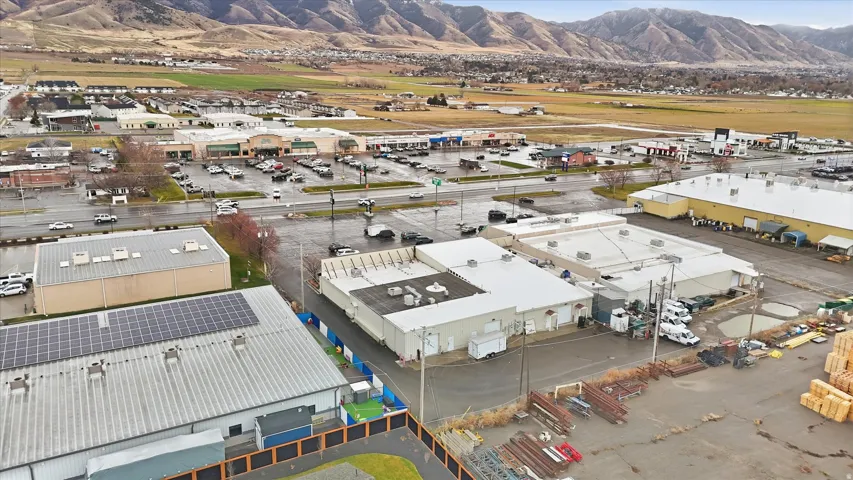 Drone / aerial view of industrial structures and a mountainous background
