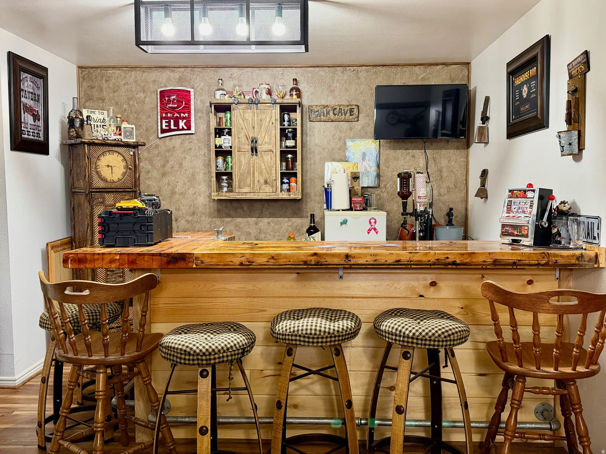 Indoor dry bar featuring wood counters and wood finished floors