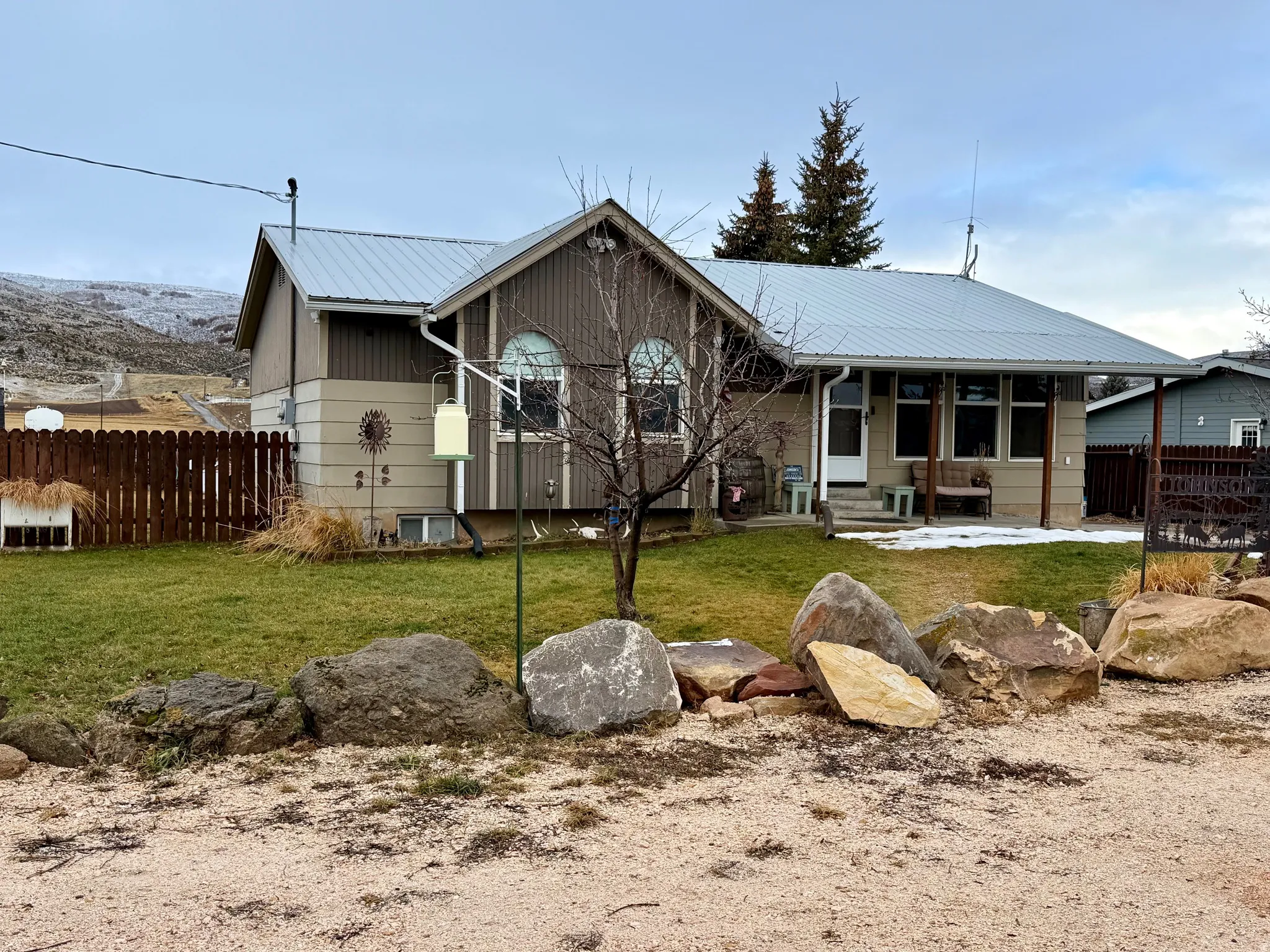 View of front facade featuring a metal roof and a patio